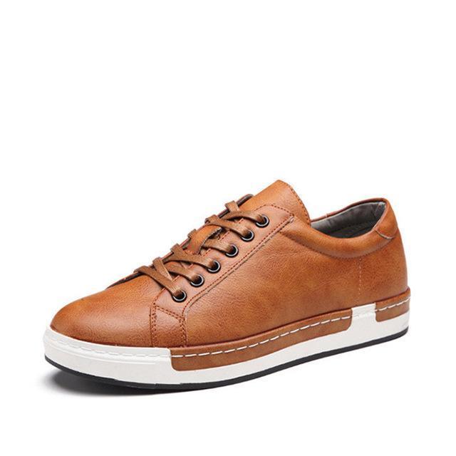 Brown leather casual sneaker with white sole and black eyelets on a white background