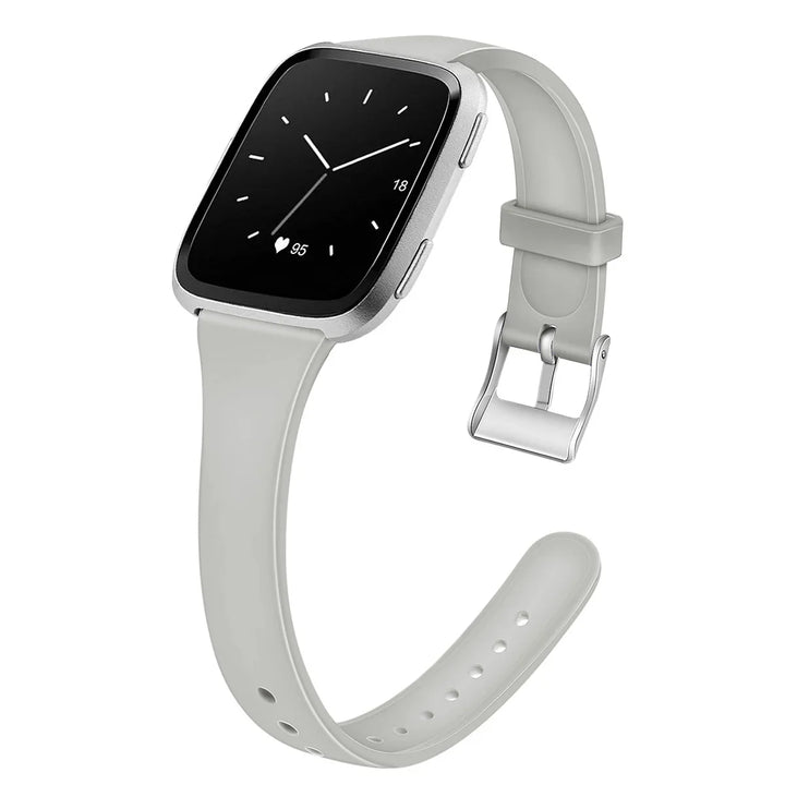 Silver smartwatch with light gray silicone strap showing heart rate and analog-style clock face