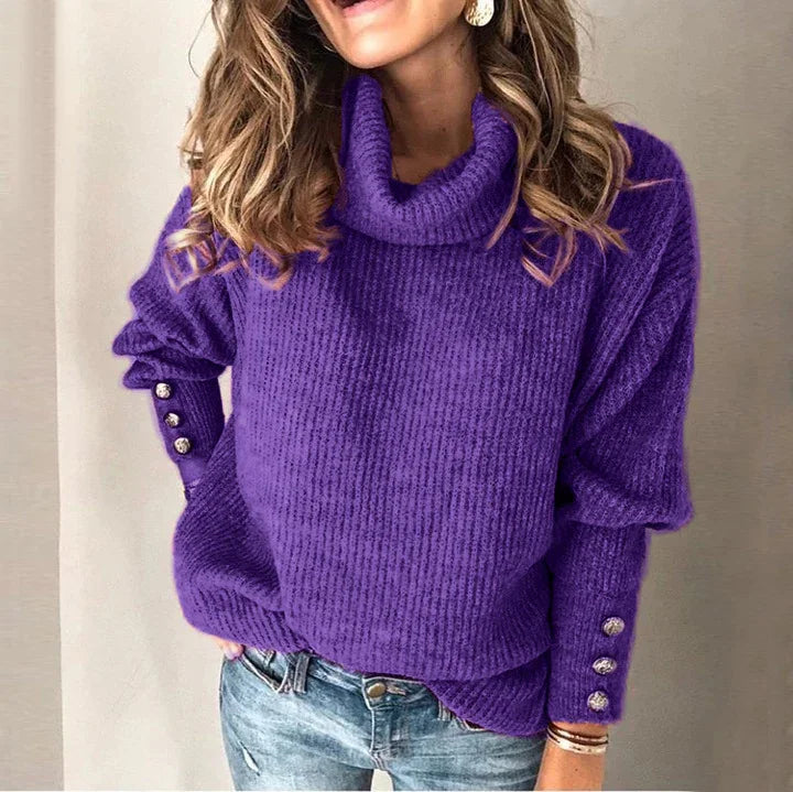 Woman wearing a cozy purple turtleneck sweater with button details on sleeves and blue jeans