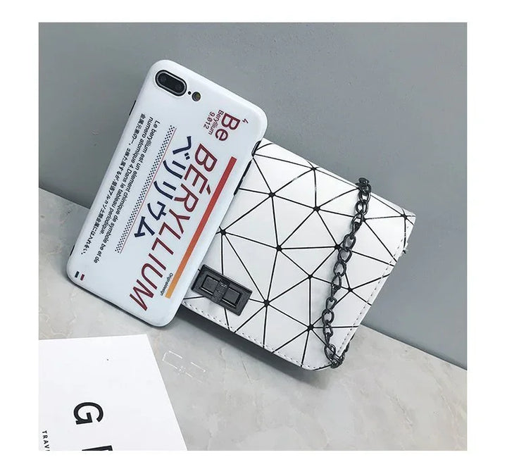 White smartphone case with text and Japanese characters next to a white geometric purse with black chain strap