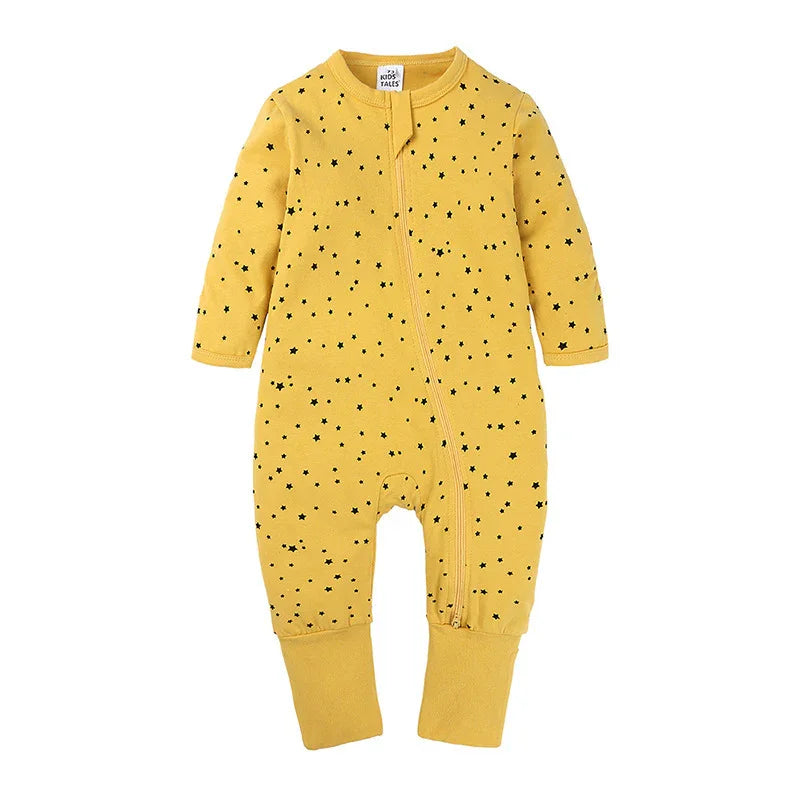 Yellow baby romper with long sleeves and black star pattern, cuffed legs, and front zipper