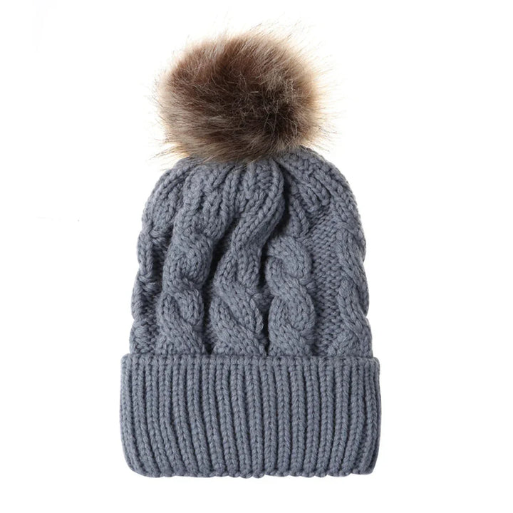 Gray knit beanie hat with cable pattern and brown faux fur pom pom on top
