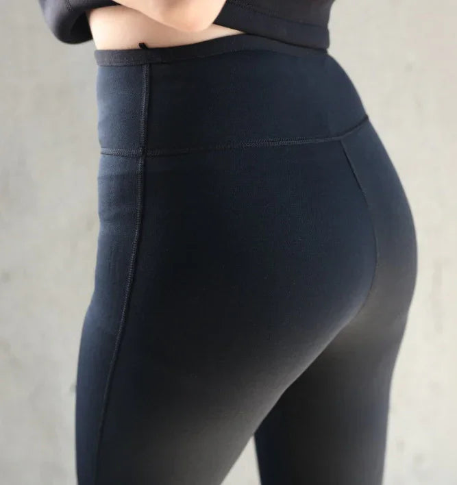 Close-up of a woman wearing high-waisted black leggings highlighting fit and stretch fabric