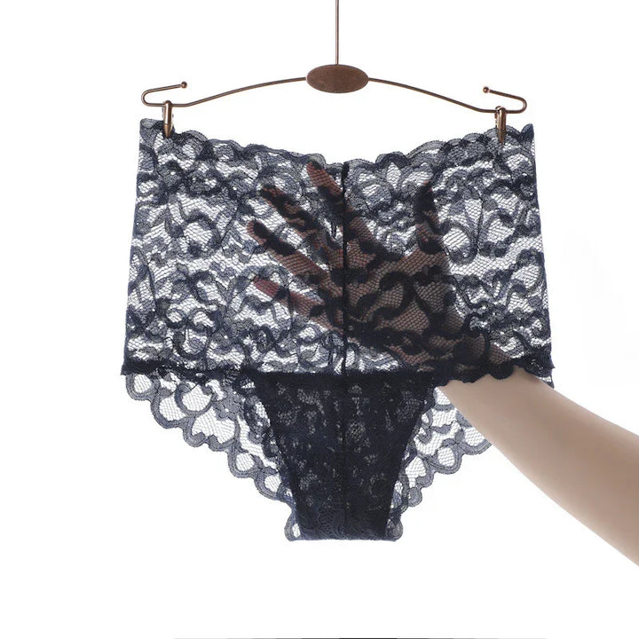 High-waisted black lace women's underwear held up on hanger with hand behind to show transparency