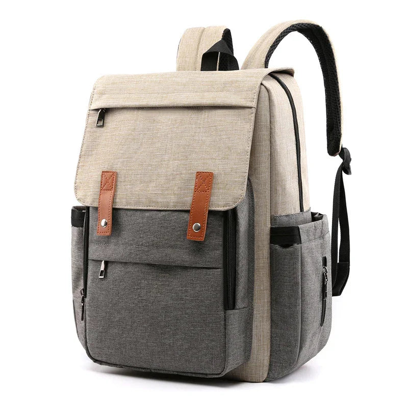 Two-tone beige and gray backpack with front flap, brown leather straps, multiple zip pockets, and padded shoulder straps