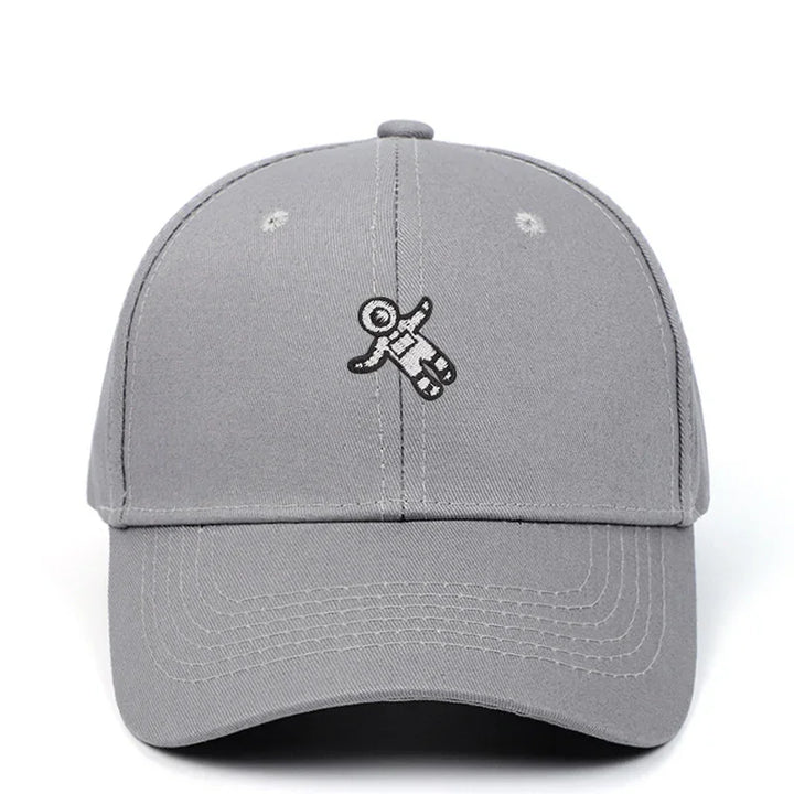 Gray baseball cap with embroidered black and white astronaut design on front