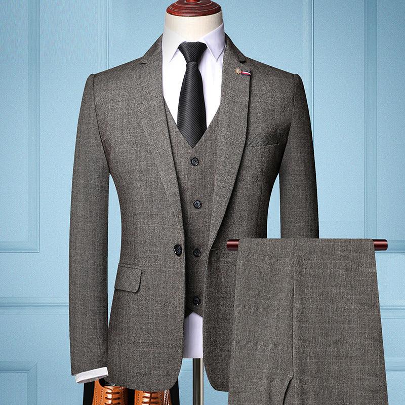 Gray three-piece men's suit with black tie on mannequin against blue paneled wall