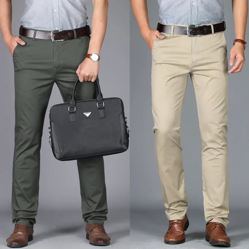 Men wearing gray button shirts with brown belts, brown leather shoes, and casual khaki and green pants; one holds black briefcase
