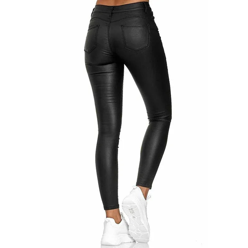 Back view of woman wearing black faux leather skinny pants paired with white sneakers on white background