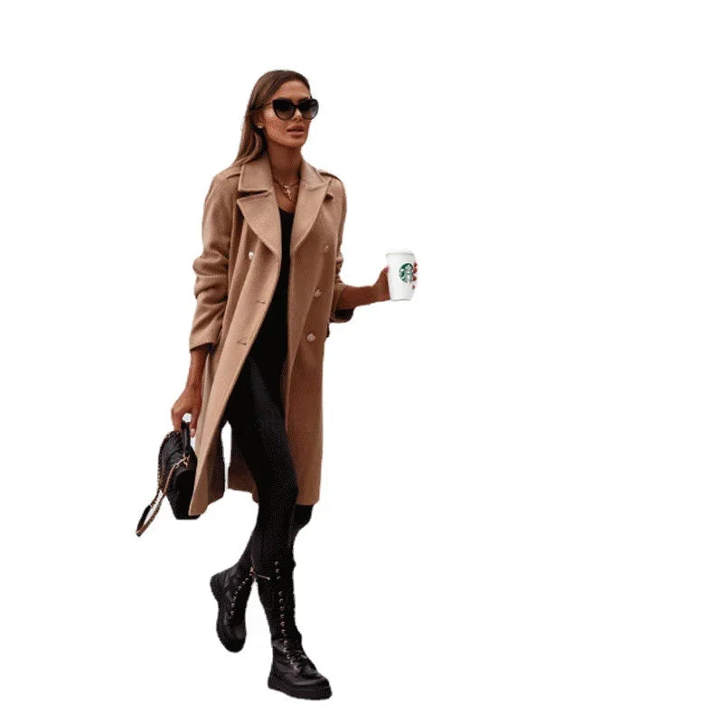 Fashionable woman in a camel coat, black leggings, boots, sunglasses holding Starbucks cup and handbag