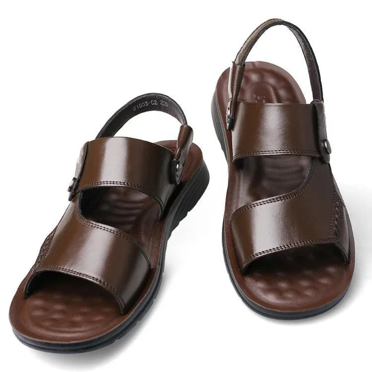 Pair of brown leather men’s sandals with adjustable straps and black cushioned soles
