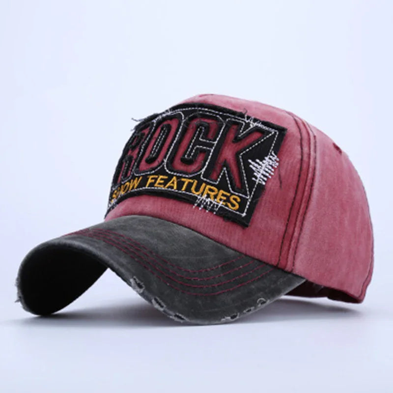 Vintage-style red and black distressed baseball cap with embroidered ROCK patch and yellow text