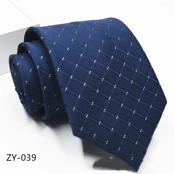 Rolled navy blue tie with subtle small white dot grid pattern, classic men's formal accessory