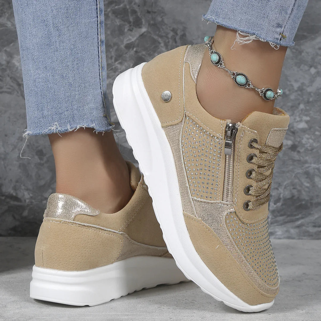 Beige suede and glitter platform sneakers with silver studs, worn with frayed blue jeans and turquoise anklet