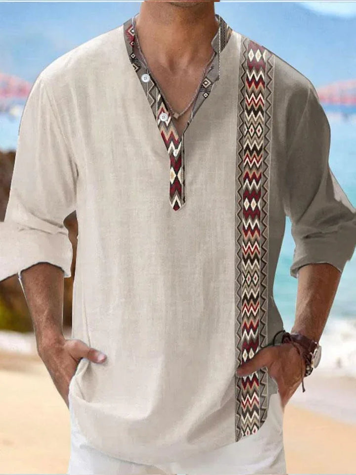 Man wearing beige casual shirt with tribal pattern detail at beach background