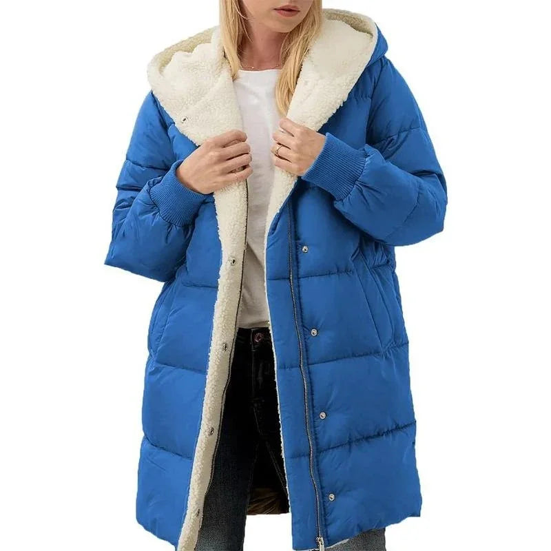 Woman wearing blue puffer coat with white sherpa lining and hood, casual winter outerwear