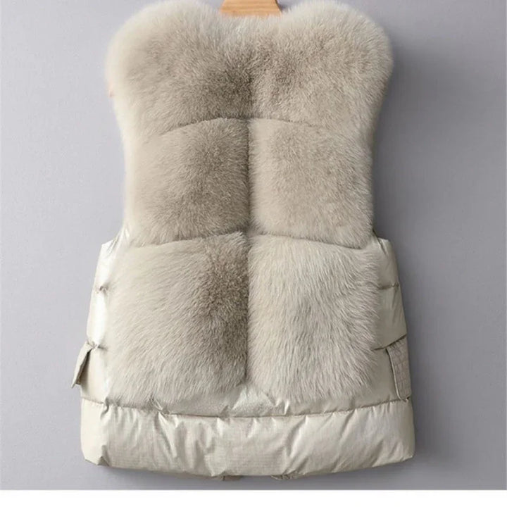 Beige fur puffer vest with four large fluffy panels hanging on wooden hanger, winter outerwear
