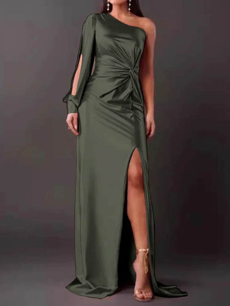 Woman wearing dark olive green one-shoulder evening gown with slit and long sleeve detail