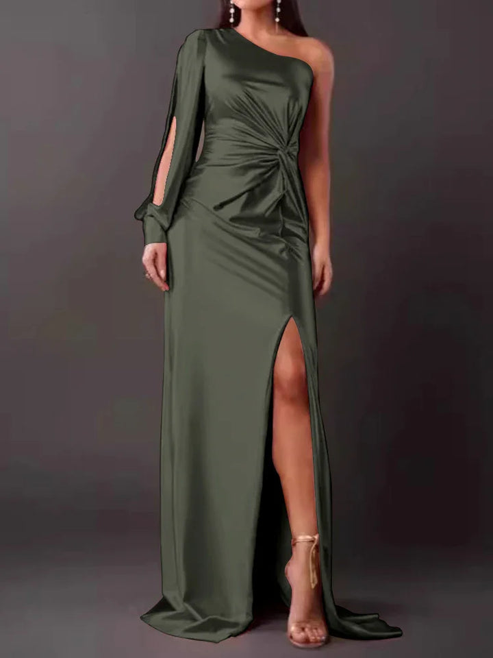 Woman wearing dark olive green one-shoulder evening gown with slit and long sleeve detail