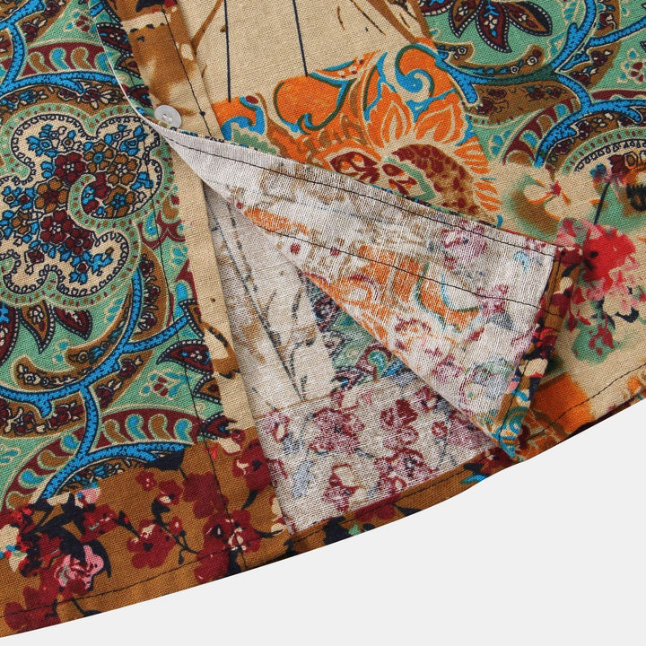 Close-up of vintage paisley and floral print fabric with folded hem showing detailed stitching