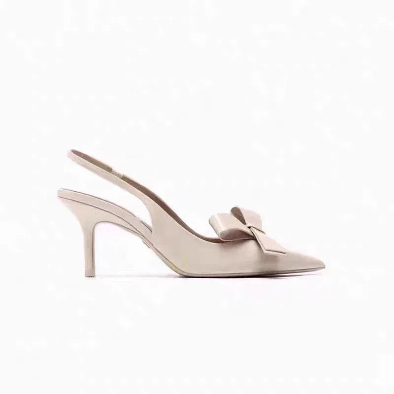 Beige leather slingback high heel shoe with pointed toe and decorative bow