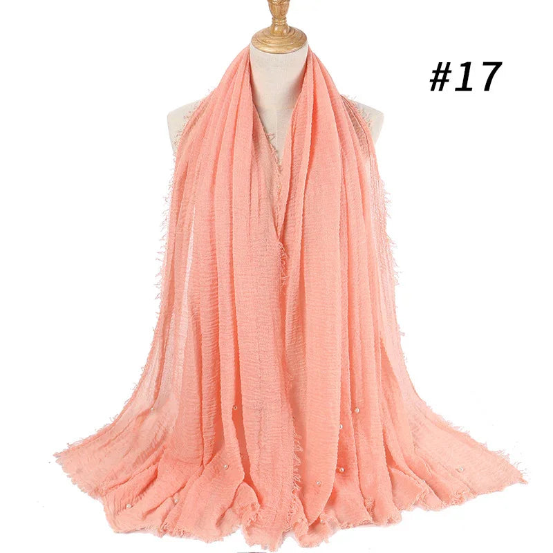 Light coral pink textured scarf with small pearls on mannequin bust with #17 label