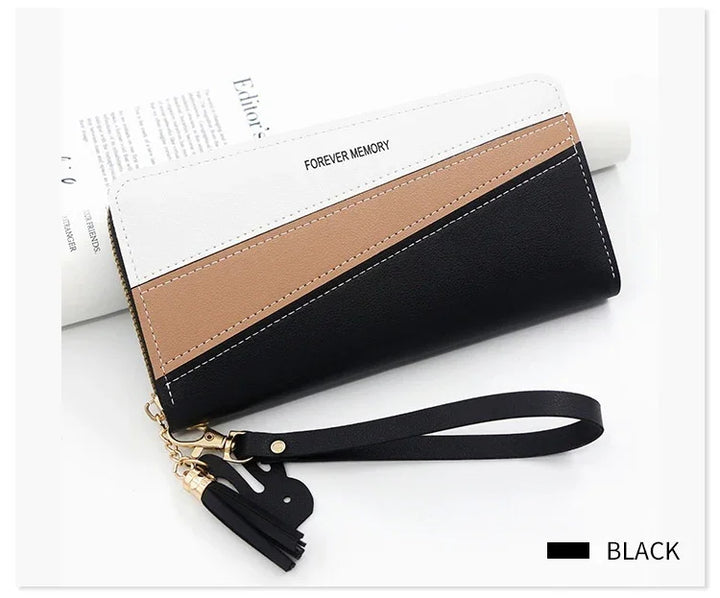Black, brown, and white color block leather wristlet wallet with tassel and strap, text Forever Memory