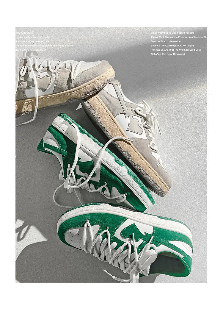 Two pairs of casual low-top sneakers with white and contrasting green and beige suede accents on a white surface