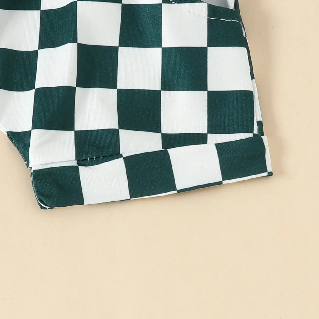 Close-up of green and white checkered fabric with stitched hem on beige background