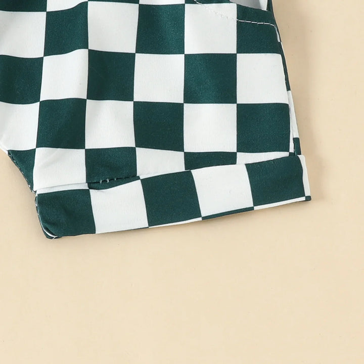 Close-up of green and white checkered fabric with stitched hem on beige background