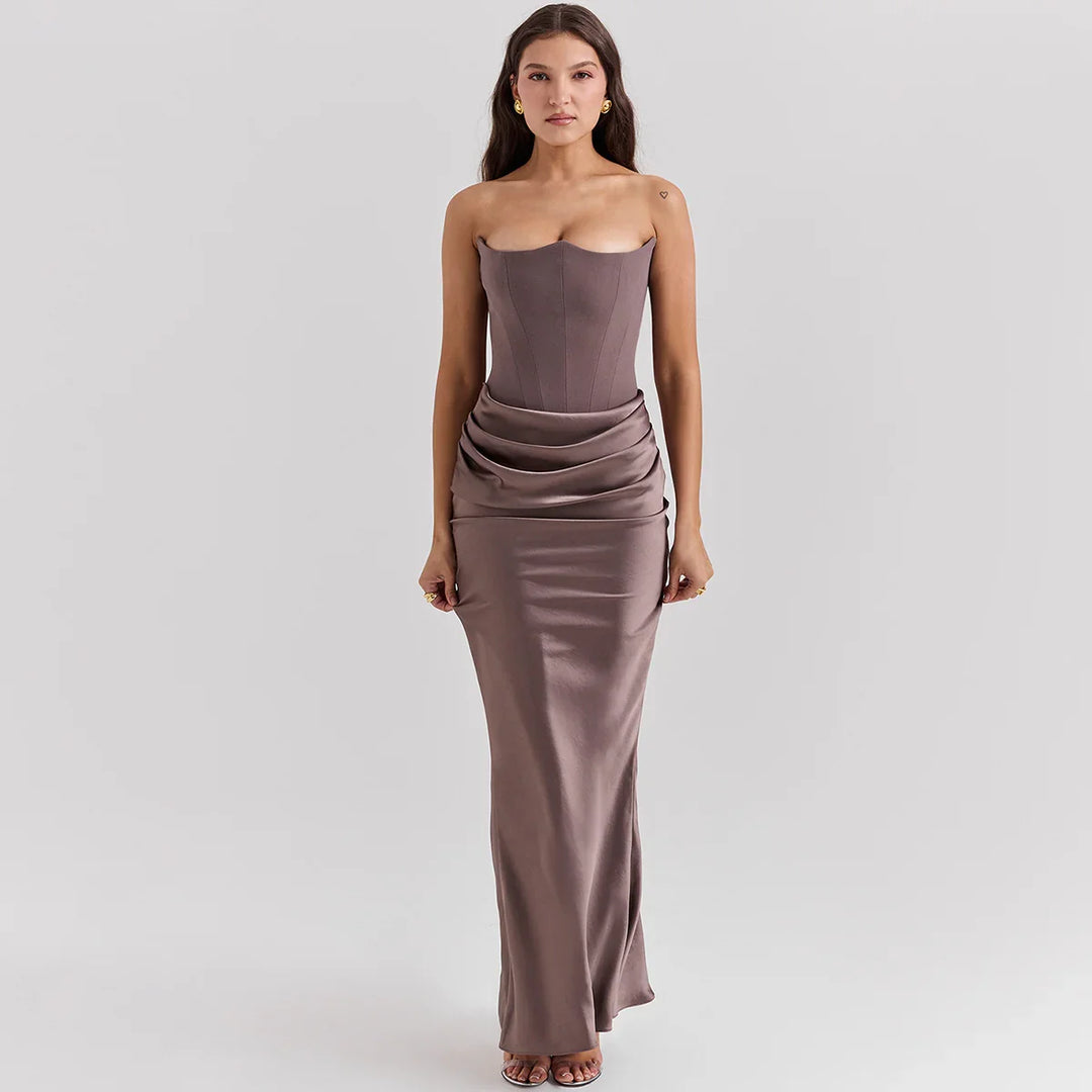 Woman wearing strapless mauve satin evening gown with draped waist and fitted bodice
