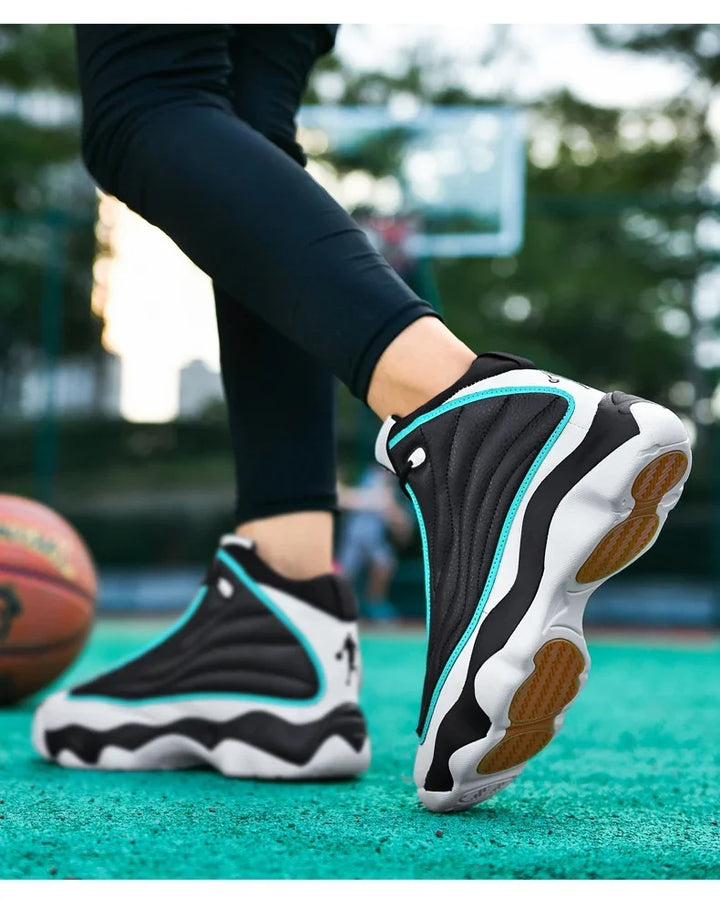 Close-up of black and white basketball shoes with turquoise accents on outdoor court