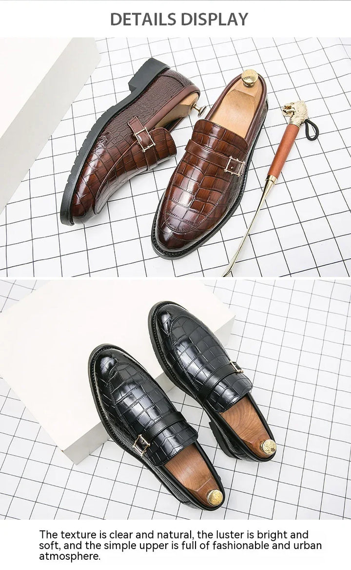 Men's crocodile-pattern leather loafers in brown and black with gold buckles on grid background