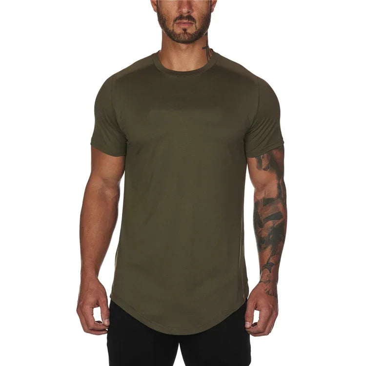 muscular man wearing olive green fitted short sleeve t-shirt with tattooed arm against white background