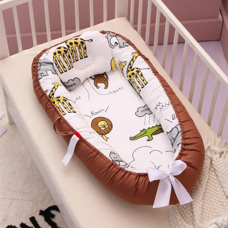 Brown and white baby nest with animal prints including giraffes, lions, and crocodiles in white crib