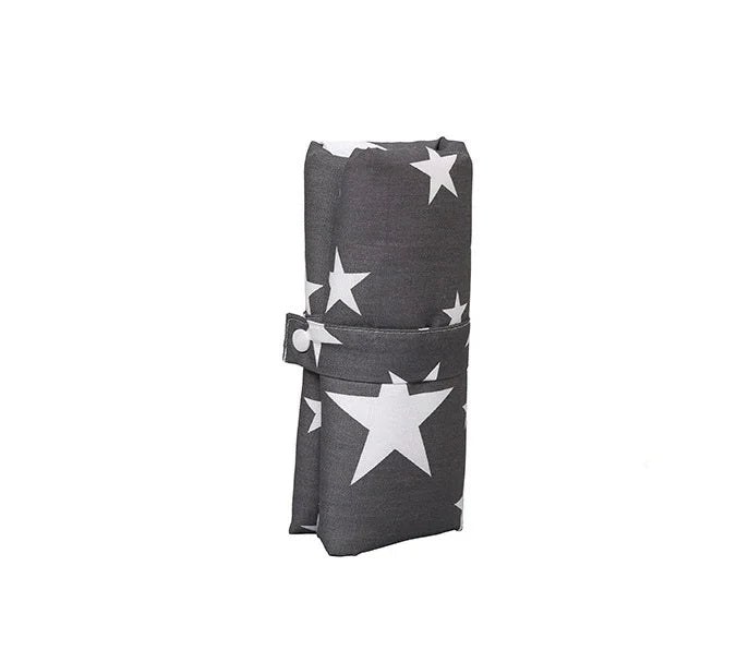 Folded dark gray fabric with large white star pattern secured with a strap against white background