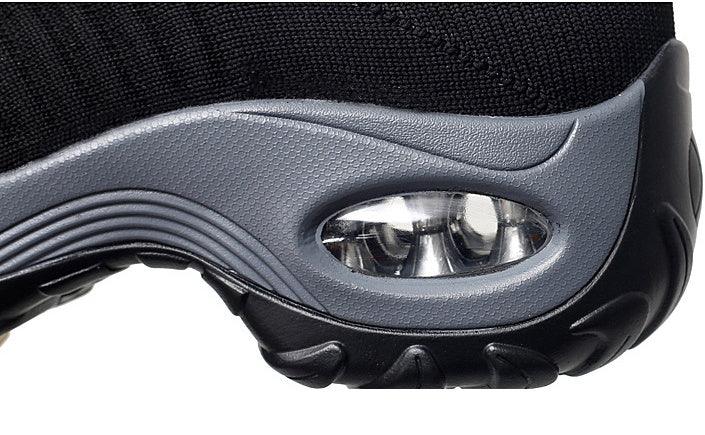 Close-up of black and gray sneaker sole with visible air cushion and textured tread