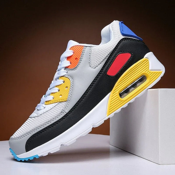 Colorful athletic sneaker with white, black, yellow, red, orange, and blue details on display