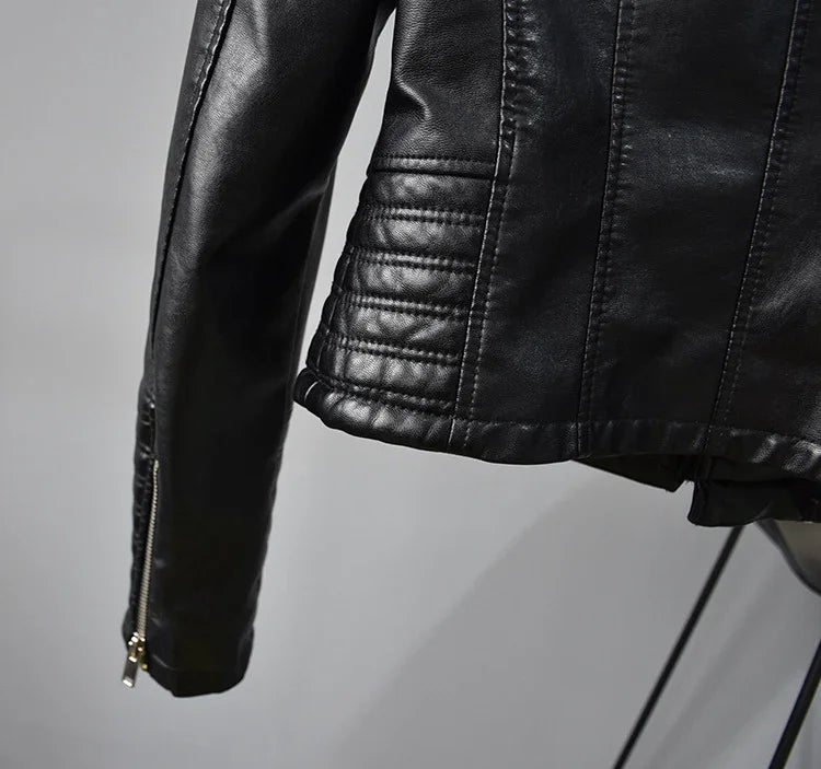 Close-up of black leather motorcycle jacket sleeve with quilted detailing and zipper