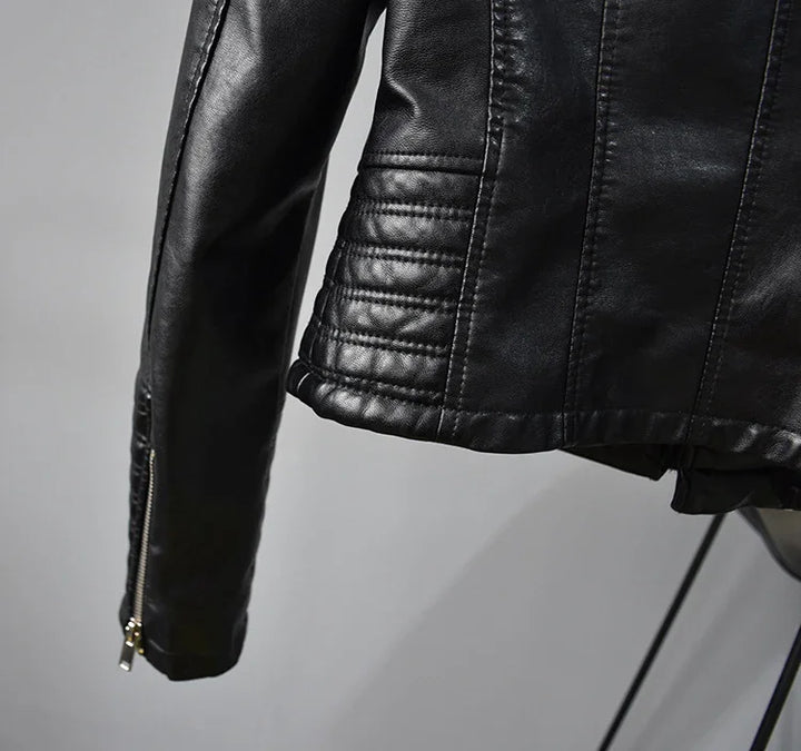 Close-up of black leather motorcycle jacket sleeve with quilted detailing and zipper