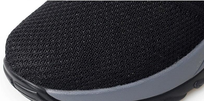Close-up of black mesh fabric running shoe with gray sole detail