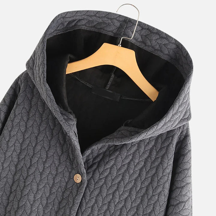 Gray quilted hooded jacket with wooden button on wooden hanger