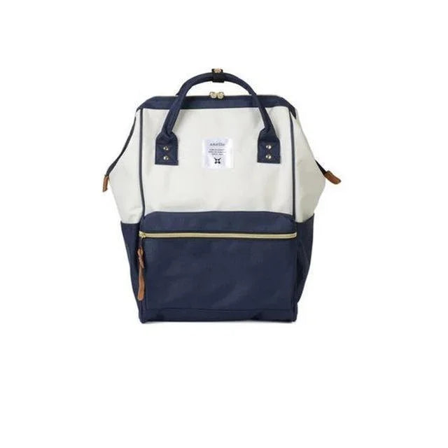 Two-tone navy and white backpack with front zip pocket and top handles