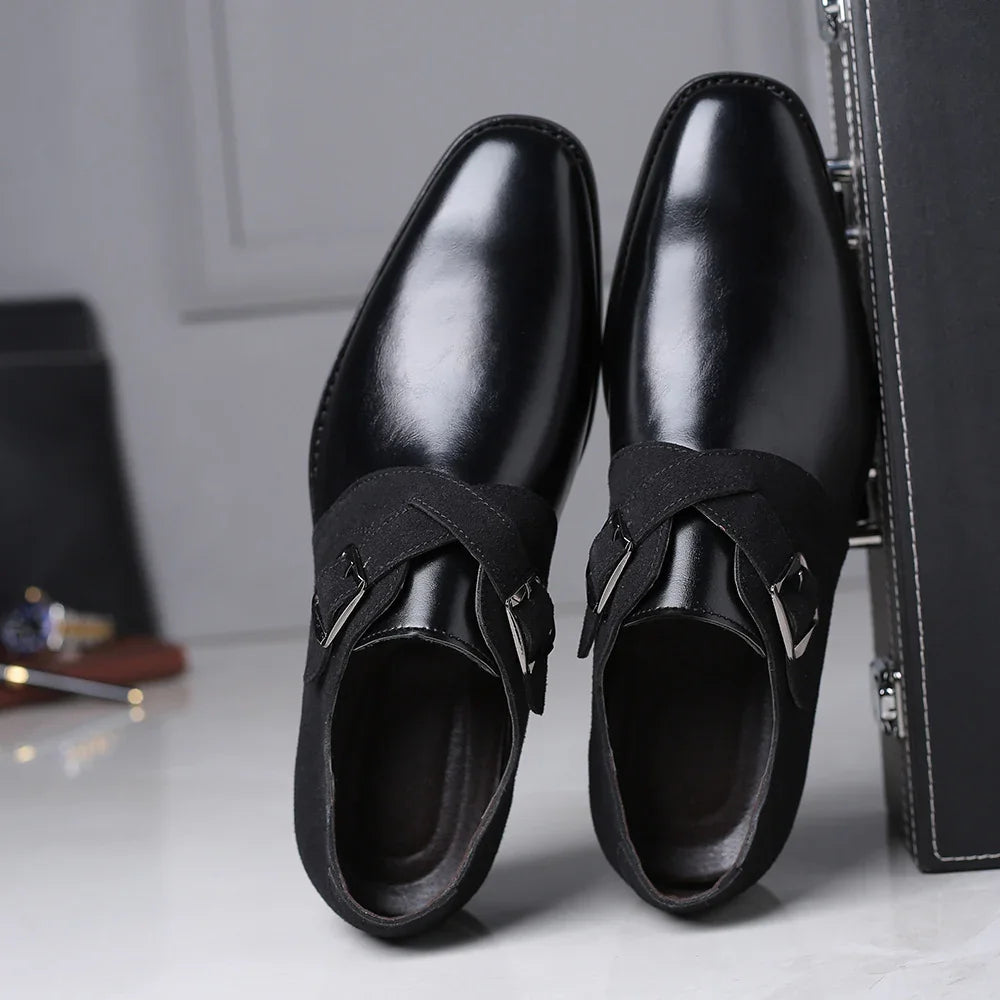 Pair of black leather monk strap dress shoes with suede buckle straps on polished floor