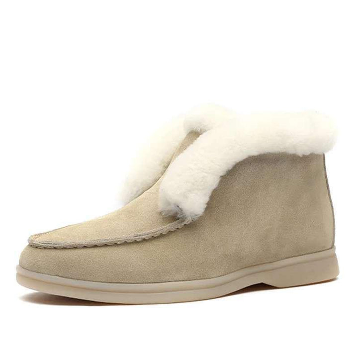 Beige suede moccasin slipper boot with white shearling lining and rubber sole