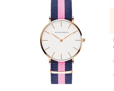 Hannah Martin minimalist watch with white dial, rose gold case, and blue-pink striped nylon strap