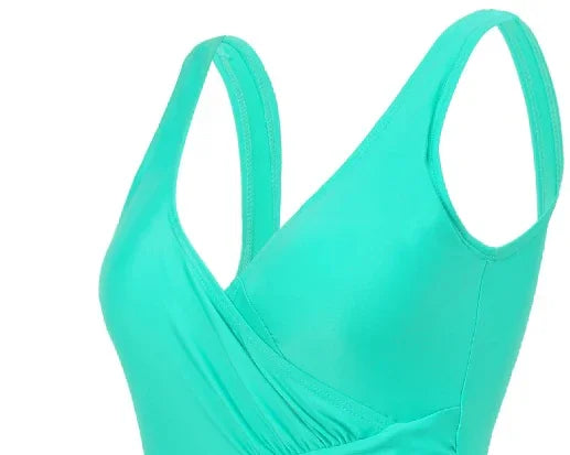Close-up of turquoise one-piece swimsuit with a deep V neckline and gathered waist detail