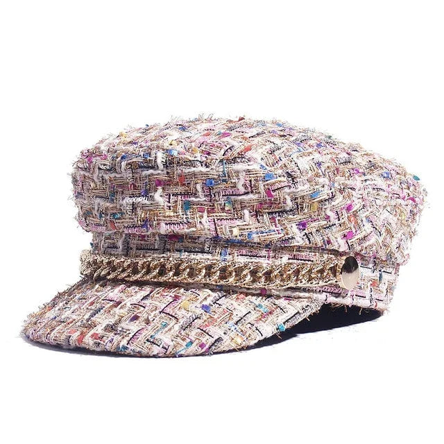 Tweed newsboy cap with multicolor fabric and gold chain detail on white background