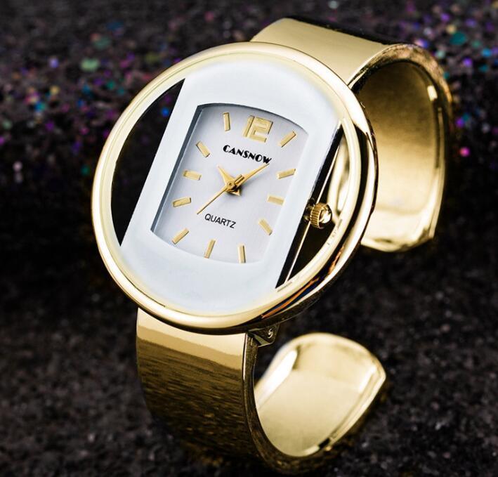 Gold CANSNOW quartz wristwatch with unique hollow circular case and gold band on dark textured background