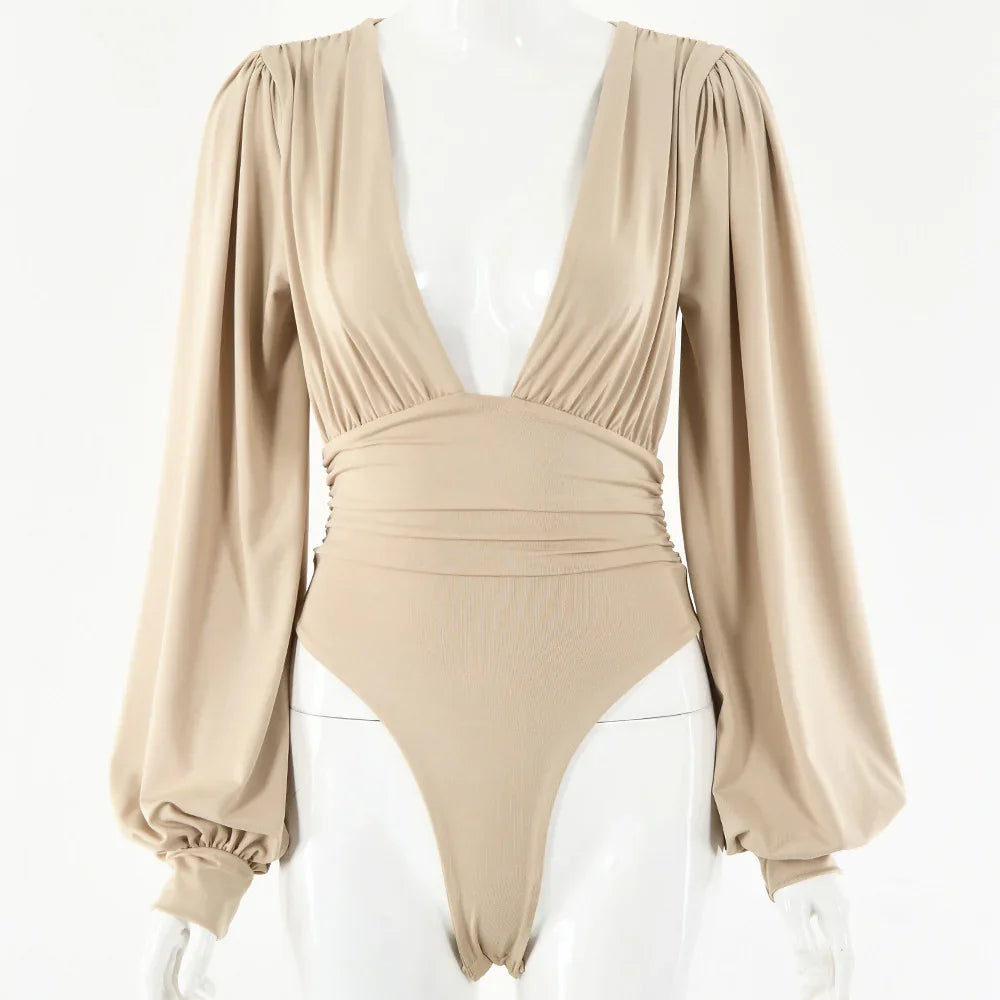 beige long sleeve bodysuit with puffed sleeves and deep V neckline on mannequin